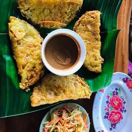 Banh xeo y los platos de hierbas que lo acompañan.
