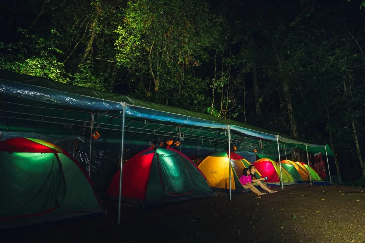 Coloured tents pitched under an overhang at the Hang Va camp