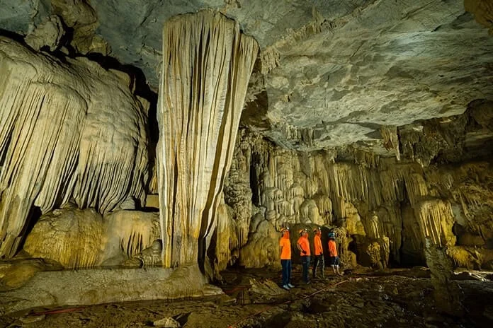 Stalactite formations lit from below in Hang Nuoc Nut